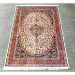 Carpet / Rug : A machine made beige ground with black, red, cream and buff colours ,