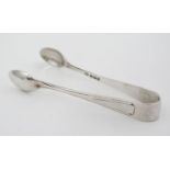 Silver sugar tongs with Art Deco style decoration.