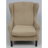 Vintage Retro: A Danish wing back armchair / lounge chair standing on turned squared legs.
