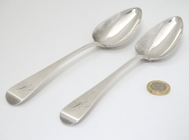 A pair of silver Old English pattern table spoons hallmarked London 1806 maker Solomon Hougham.