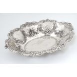 An silver dish with embossed and pierced decoration. Hallmarked Birmingham 1901 maker JG.