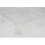 Mid Century : a large Lucite ? coffee table with four legs and canted corners ,