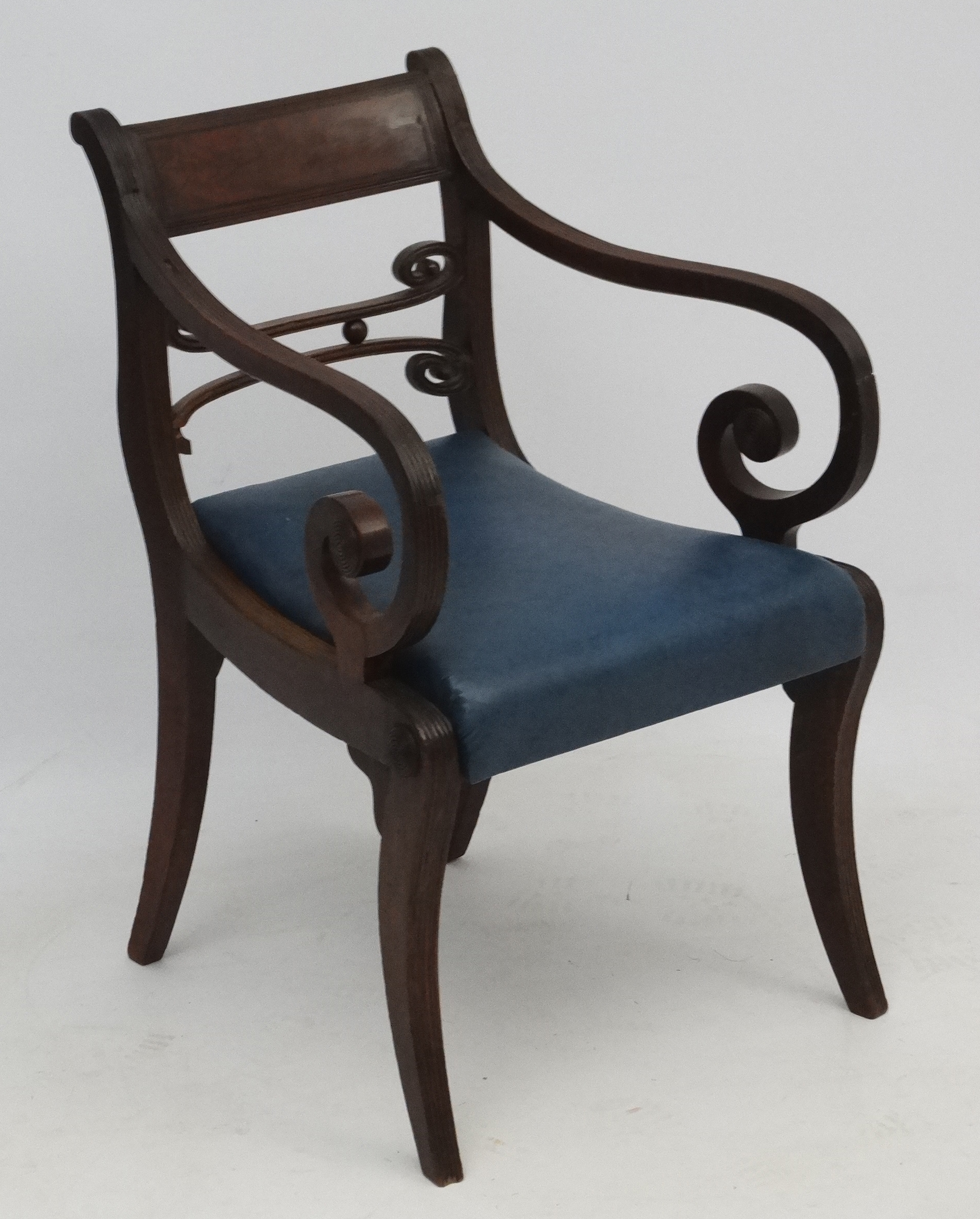 A Regency mahogany open arm / carver chair with sabre legs and drop in seats 32 1/2" high