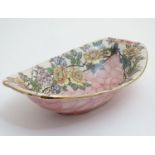 A Maling ' Rosine ' pattern pink lustre bowl decorated with trails of flowers in polychrome with