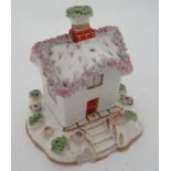 A 19thC Staffordshire Cottage pastille burner, having bocage and floral details. 3 3/4'' high.