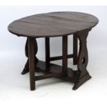 An early 20thC oak table of oval drop flap gate leg form 51 1/2" wide (open) x 38" long x 29" high