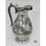 A 19thC pewter hot water jug with hinged lid with grapevine decoration,