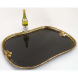 An early 19thC papier mâché black lacquered and gilt shaped tray.