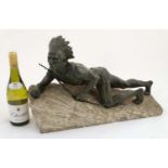 An Art Deco green patinated bronze figure on stone base depicting a North American Indian with bow.