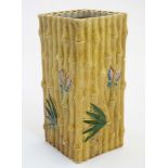 A Chinese vase decorated in relief with bamboo, palm leaves and butterflies,