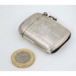 A silver vesta case of shaped formed with engine turned decoration and gilded interior.