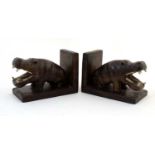 A pair of 20thC carved wooden bookends in the form of segent hippos.