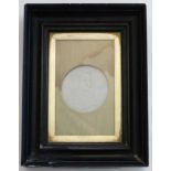 A black framed plaque Lithophane formed as a circular medallion depicting a child with a bird 3"