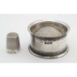 A silver napkin ring hallmarked Birmingham 1909 maker William Hair Haseler together with a silver