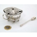 A silver mustard pot with hinged lid and blue glass liner hallmarked Sheffield 1896 maker Atkin