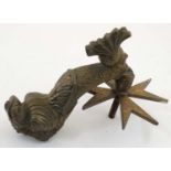 A Maltese cast brass door knocker in the form of a dolphin.