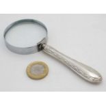 A silver handled magnifying glass.