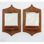 A pair of red velvet wall sconces with bevelled edge mirror backs.