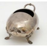 A silver plate spoon warmer of ovoid form on four lions paw feet and with ropetwist handles.