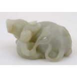 A Chinese pale grey/green jade figure of a recumbent water buffalo and figure, possibly Imperial.