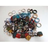 A large quantity of assorted costume jewellery to include bracelets,