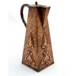 Decorative Metalware : An Art Nouveau copper jug of squared tapering form with hammered and