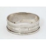 An Art Deco silver napkin ring with engine turned decoration Hallmarked London 1935 with Silver