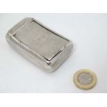 A Geo III silver snuff box of shaped form with banded decoration. Hallmarked London 1810 maker WE. 2