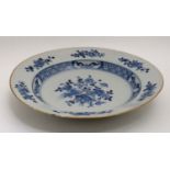 A blue and white Chinese ceramic plate. Decorated with flora in central well and border. 9''