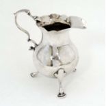 A Geo III silver cream jug hallmarked London 1763 maker SM 4" high CONDITION: