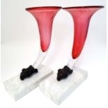 A 21stC matched pair of cranberry glass epergne / vases with rams head mounts and composite marble