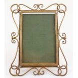 A late Victorian brass easel / strutt photograph frame with decorative wirework border to frame,