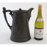 A large pewter biggin / hot water jug with figural decoration to handle and engraved decoration to