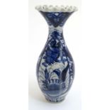 A Japanese blue and white vase having ruffled flared rim and decorated with stylised flora. 9 3/