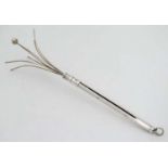 A silver retractable swizzle stick with engine turned decoration. hallmarked Birmingham 1957 maker S