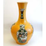 A large Chinese bottle neck vase with flared rim , the sides decorated with famille verte vases in a