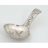 A Geo III silver caddy spoon with engraved decoration,