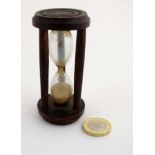 A small sand timer / sand glass,