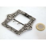 An embossed white metal buckle with cast decoration Approx 2 /4" wide CONDITION: