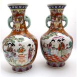 A pair of Oriental vases having panels decorated with female figures in a garden scene , having