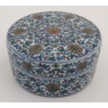 A Chinese circular lidded pot. Hand painted with floral and foliate details. Bearing 6 Chinese