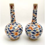 A pair of Chinese blue and white bottle vases decorated with lucky symbols in orange , including the