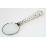 A silver handled magnifying glass. The whole 5"" long CONDITION: Please Note - we do not make