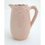 A mid 20thC Clarice Cliff, Newport Pottery Co, pink jug having crabstock handle and leaf