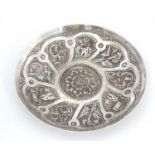 A white metal dish with embossed foliate and building decoration 5 1/4"" diameter CONDITION: