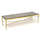 Mid Century Modern - Manner of Maison Jansen - a gilt brass and smoked glass topped long low table