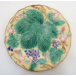 A c1900 Wedgwood Majolica Leaf, Strawberry and Grape pattern plate , decorated in shades of pink ,