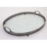 An oval glass and silver plate tray with loop handled and pierced gallery 21 1/4" wide