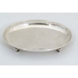 A silver oval pin tray on four feet. Hallmarked Birmingham 1922 maker Sydney & Co. 4 1/8"" wide (