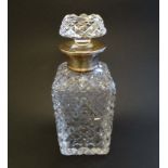 A cut glass decanter of squared form with silver collar hallmarked 1957 maker Roberts & Dore Ltd.